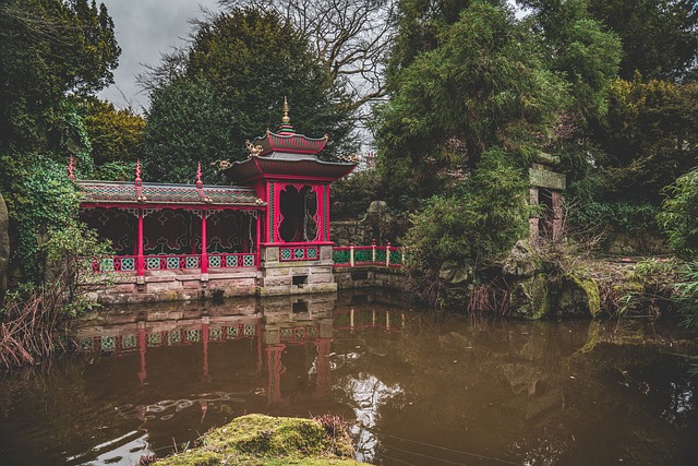 Red riverside pavilion over calm pond